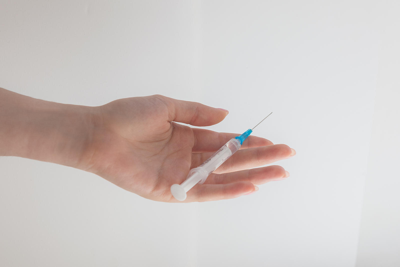 Syringe In Hand: Needle On The Palm, Injection From The Disease,